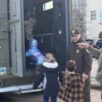 Verlan helping Cub Scouts Pack 378 explore "the Bear" (used by SWAT) as part of their visit to the Law Enforcement Center in Williston on March 16.